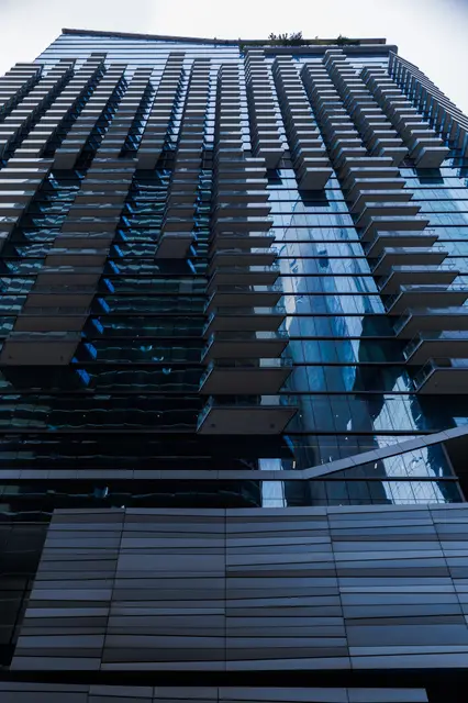 Looking up the glass facade of the host tower
