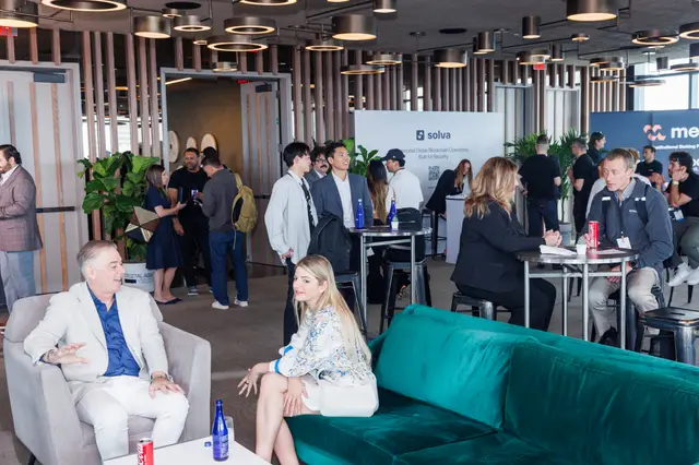 Guests gathered in the sunlit networking lounge